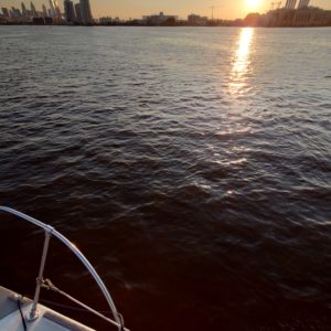 A view of the sunset over Philadelphia from the bow of a sailboat - © James Jackson - raveneyes.com